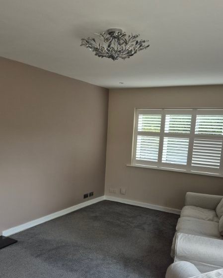 Living room after decorating, with freshly painted walls, ceiling and skirting